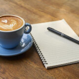 a notebook and coffee