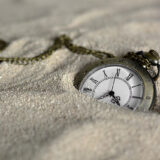 a watch sinking in sand