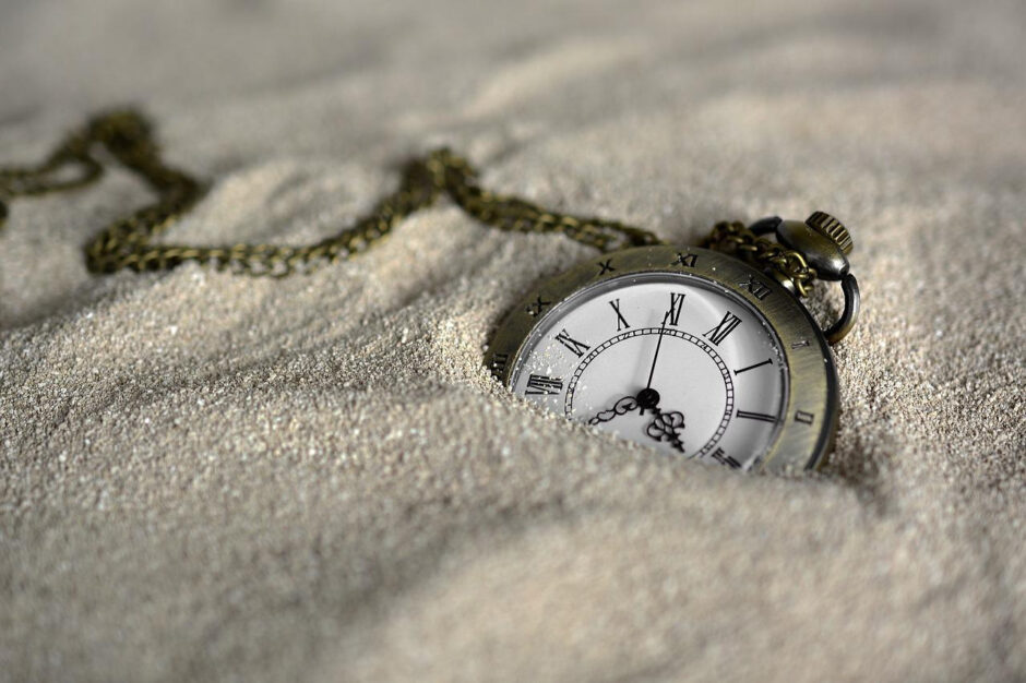 a watch sinking in sand