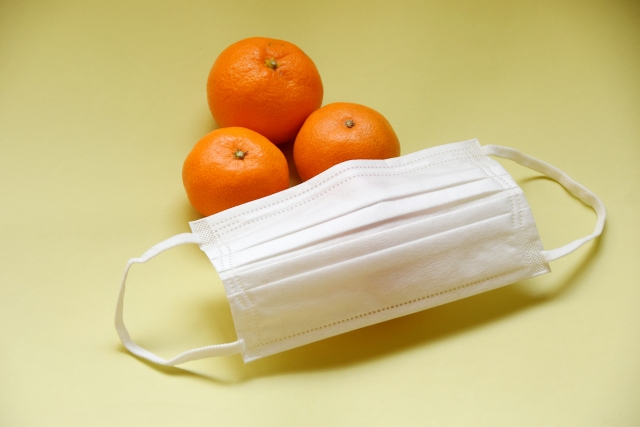 a disposable mask and oranges.